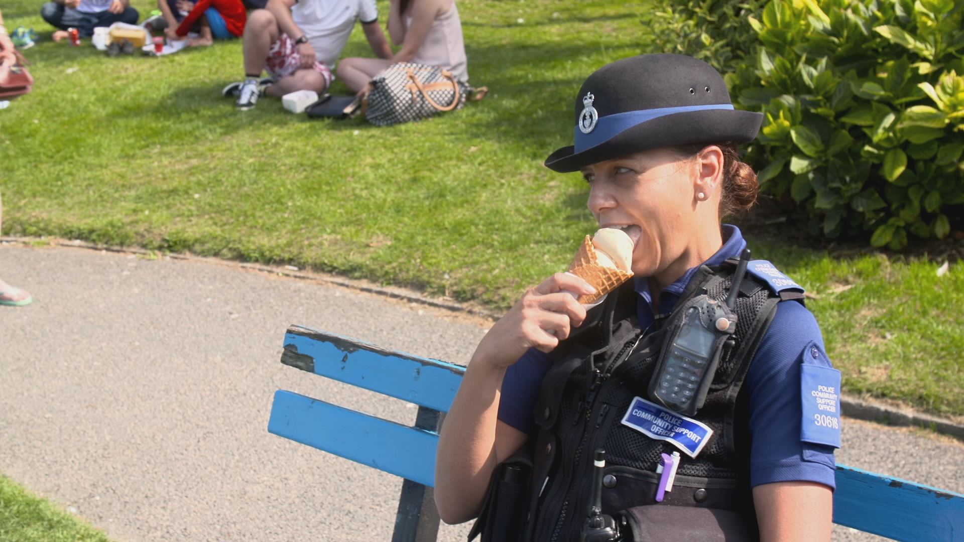 devon and cornwall cops - policewoman eating an ice cream on a bench
