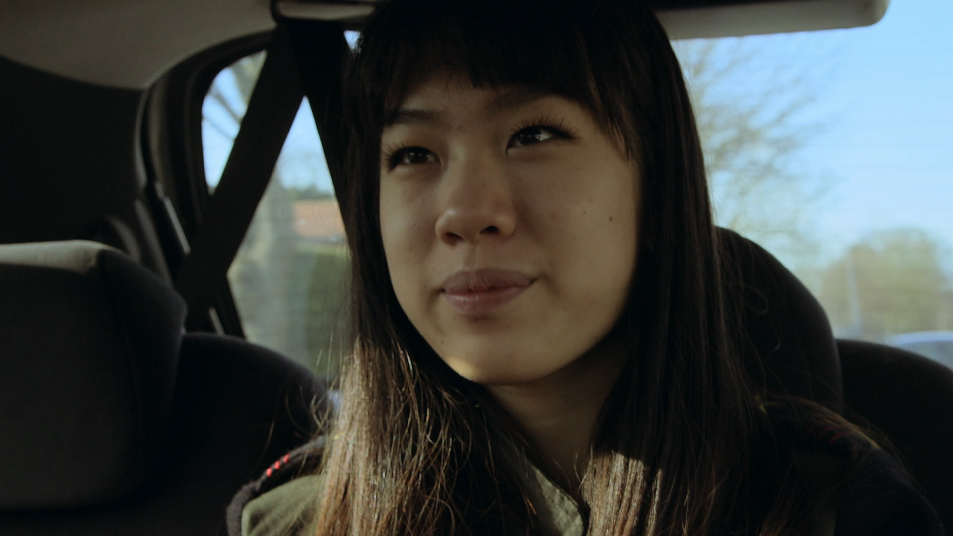 My Life: Adopted from China - close up of girl's face in sat in a car